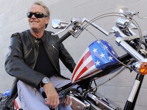 In this 2009 file photo, Peter Fonda, poses atop a Harley-Davidson motorcycle  in Glendale, Calif. Fonda, the son of a Hollywood legend who became a movie star in his own right both writing and starring in counterculture classics like "Easy Rider," has died at age 79.