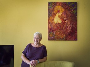 Stem cell recipient Luba Banuke, in her Coquitlam home in front of a painting her daughter Maria gave her, has been cancer-free for 10 years after initially being told her blood cancer was terminal.