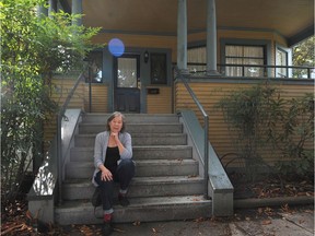 Judy Graves, who lives across the street, sits on the front porch of the three-bedroom West End suite that was, until last week, being advertised on Craigslist for $2,850 a month.
