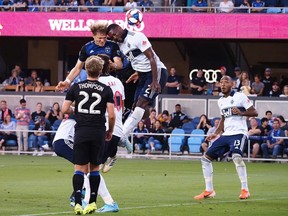Aug 24, 2019; San Jose, CA, USA; San Jose Earthquakes midfielder Florian Jungwirth (23) and Vancouver Whitecaps defender Doneil Henry (2) battle for a header during the first half at Avaya Stadium. Mandatory Credit: Kelley L Cox-USA TODAY Sports