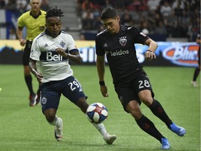 D.C. United defender Joseph Mora battles Vancouver Whitecaps forward Jordy Reyna for the ball during the second half at B.C. Place on Saturday. Photo: Anne-Marie Sorvin/USA Today Sports