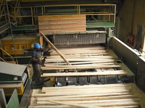 Rough sawn lumber is inspected at Tolko’s Soda Creek Division stud sawmill in Williams Lake.