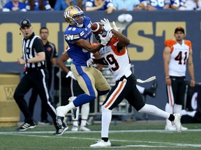 Receiver Kenny Lawler of the Winnipeg Blue Bombers is unable to make the catch under tight coverage from B.C. Lions' defensive back Crezdon Butler during CFL action in Winnipeg on Thursday. The Bombers hung on to the victory, however, their seventh win in nine games. The Lions slipped to 1-8.