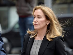 Actress Felicity Huffman is escorted by police into court where she pled guilty to one count of conspiracy to commit mail fraud and honest services mail fraud before Judge Talwani at John Joseph Moakley United States Courthouse in Boston, Massachusetts, May 13, 2019. (Photo by Joseph Prezioso / AFP)J