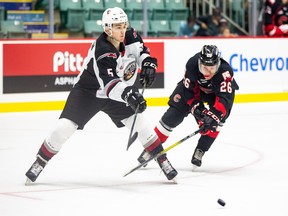 Vancouver Giants defenceman Jacob Gendron eludes Prince George Cougars winger Reid Perepeluk during Vancouver's 4-1 win Saturday in Prince George. Gendron, a Prince George native, was making his WHL debut there this weekend.