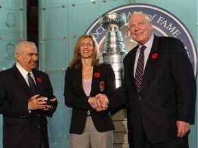 Cammi Granato is presented with her Hall of Fame ring by Jim Gregory, leftr and Don Hay before her induction ceremony at the Hockey Hall of Fame on Nov. 8, 2010 in Toronto.