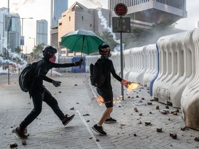 A pro-democracy protester throws a petrol bomb at the Central Government Offices on Sept. 15, 2019 in Hong Kong, China. Pro-democracy protesters continued demonstrations across Hong Kong.