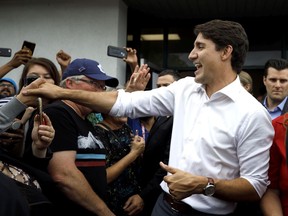 Prime Minister Justin Trudeau greets supporters as he departs a campaign stop Monday in Niagara Falls, Ont.
