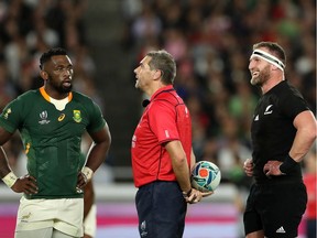 Captains Siya Kolisi (left) of South Africa Kieran Read of New Zealand and talk to referee Jerome Garces as he conducts a video review during the Rugby World Cup 2019 Group B game between New Zealand and South Africa at International Stadium Yokohama on September 21, 2019 in Yokohama, Kanagawa, Japan.