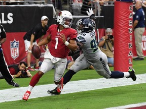 GLENDALE, ARIZONA - SEPTEMBER 29: Kyler Murray #1 of the Arizona Cardinals looks to throw the ball while avoiding a sack in the back of the end zone by Rasheem Green #98 of the Seattle Seahawks during the first half at State Farm Stadium on September 29, 2019 in Glendale, Arizona.