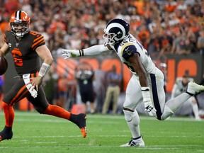 Cleveland Browns quarterback Baker Mayfield runs from a Rams defender last week. (GETTY IMAGES)