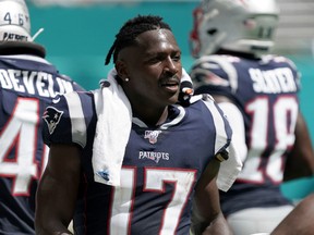 New England Patriots wide receiver Antonio Brown (17) watches from the sidelines in the second half against the Miami Dolphins at Hard Rock Stadium in Miami Gardens, Florida on Sept. 15, 2019.