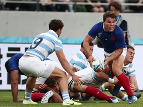 France's scrum-half Antoine Dupont (R) looks to pass the ball during the Japan 2019 Rugby World Cup Pool C match between France and Argentina at the Tokyo Stadium in Tokyo on September 21, 2019.