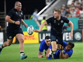 Scotland's fly-half Finn Russell passes the ball  during the Japan 2019 Rugby World Cup Pool A match between Scotland and Samoa at the Kobe Misaki Stadium in Kobe on September 30, 2019.