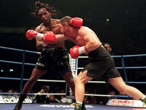 In this Nov. 9, 1996, file photo, Nigel Benn (L) ties to dodge a punch thrown by Steve Collins during their bout.