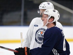 Tyler Benson (right) and Ostap Safin watch a drill during Edmonton Oilers Rookie Camp at Rogers Place in Edmonton, on Sunday, July 8, 2019.