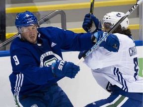 Vancouver Canucks forward J.T. Miller (left) crashes into Jalen Charfield during Training Camp at the Save-On-Foods Arena in Victoria. Photo: Gerry Kahrmann/Postmedia