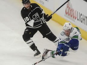Vancouver Canucks right wing Brock Boeser, right, stumbles as he tries to pass in front of L.A. Kings centre Michael Amadio during a preseason game on Saturday.
