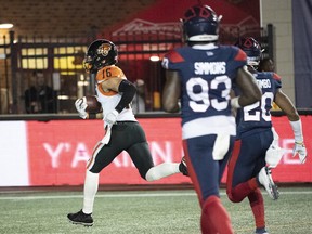 B.C. Lions wide receiver Bryan Burnham breaks away form Montreal Alouettes' defensive end Antonio Simmons (93) and linebacker Boseko Lokombo to score a touchdown during second quarter CFL football action in Montreal earlier this month.