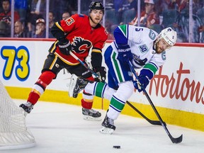 Vancouver Canucks defenceman Oscar Fantenberg, in pre-season action Sept. 16 against the Calgary Flames and Sam Bennett, was back skating with his teammates on Saturday after suffering a concussion last week.