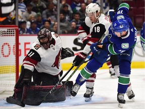 Vancouver Canucks forward Michael Ferland (79) shoots the puck against Arizona Coyotes goaltender Adin Hill (31) and forward Christian Dvorak (18) during the first period at Rogers Arena.