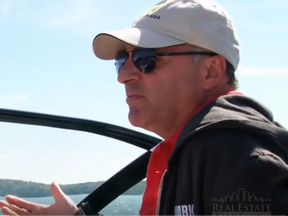 Businessman Kevin O'Leary behind the wheel of one of his boats on Lake Joseph.