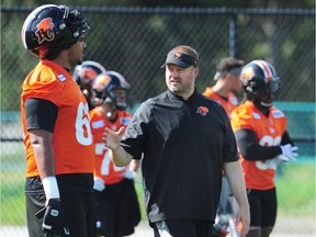 Newly hired B.C. Lions offensive line coach Kelly Bates works with his linemen at practice on Tuesday.