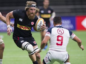 Canada's Evan Olmsted carries the ball against U.S. defender Nate Augspurger during their international rugby test at B.C. Place Stadium on Sept. 7, 2019.