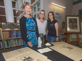 Principal Janet Souther (left) shows off the contents of Shaughnessy Elementary's time capsule with the co-chairs of the school's centenary committee, Chelsea Miller and Sabrina LaFrance.