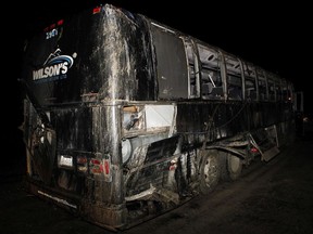 A passenger bus involved in an accident along a logging road Friday night is carried from the crash scene by a tow-truck near Bamfield, B.C. on Saturday, September 14, 2019. Two 18-year-old students, a woman from Manitoba and an American man, have been identified as the victims of a fatal bus crash on Vancouver Island.