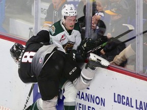 In battle of No. 8 jerseys, Vancouver Giants winger Tristen Nielsen gets tangled up with Everett Silvertips defenceman Ronan Seeley in Everett's 3-2 victory Friday at the Langley Events Centre.