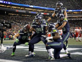 Ed Dickson of the Seattle Seahawks poses with teammates after scoring a touchdown  against the Kansas City Chiefs at CenturyLink Field on Dec. 23, 2018.