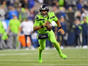 Seahawks QB Russell Wilson scrambles out of the pocket during the game against the Los Angeles Rams at CenturyLink Field in Seattle on Thursday.