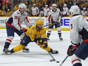 Lars Eller #20 of the Washington Capitals tries to tie up Roman Josi #59 of the Nashville Predators during the third period of a 6-5 Predators victory over the Capitals at Bridgestone Arena on October 10, 2019 in Nashville, Tennessee.