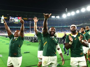 South Africa's Mbongeni Mbonambi, Tendai Mtawarira and captain Siya Kolisi (left to right) celebrate their 19-16 Rugby World Cup semifinal win over Wales at International Stadium in Yokohama, Japan, on Oct. 27, 2019.