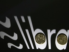 Shadow of a 3D-printed Facebook Libra cryptocurrency logo is seen near cryptocurrency representation in this illustration taken, Sept. 13, 2019. REUTERS/Dado Ruvic/File Photo/File Photo/File Photo