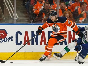 Edmonton Oilers' Leon Draisaitl (29) battles Vancouver Canucks' Quinn Hughes (43) during first period NHL action at Rogers Place in Edmonton, on Wednesday, Oct. 2, 2019. Photo by Ian Kucerak/Postmedia