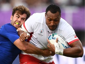 Tonga's David Halaifonua (R) is tackled by France's Damian Penaud during the Japan 2019 Rugby World Cup Pool C match between France and Tonga at the Kumamoto Stadium in Kumamoto on October 6, 2019.