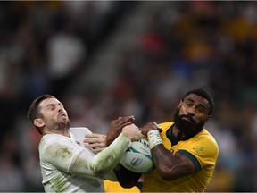 England's full back Elliot Daly (L) fights for the ball with Australia's wing Marika Koroibete during the Japan 2019 Rugby World Cup quarter-final match between England and Australia at the Oita Stadium in Oita on October 19, 2019.