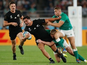 TOPSHOT - New Zealand's centre Anton Lienert-Brown (2nd L) is tackled during the Japan 2019 Rugby World Cup quarter-final match between New Zealand and Ireland at the Tokyo Stadium in Tokyo on October 19, 2019. (Photo by Odd Andersen / AFP)