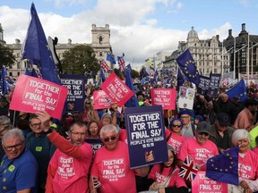 Demonstrators with placards and EU and Union flags gather in Parliament Square in central London on October 19, 2019, as they take part in a rally by the People's Vote organisation calling for a final say in a second referendum on Brexit.