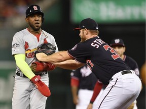 Oct 14, 2019; Washington, DC, USA; Washington Nationals starting pitcher Stephen Strasburg (37) tags St. Louis Cardinals left fielder Marcell Ozuna (23) out during the second inning in game three of the 2019 NLCS playoff baseball series at Nationals Park. Mandatory Credit: Tommy Gilligan-USA TODAY Sports