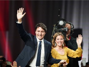 Liberal leader Justin Trudeau and wife Sophie Gregoire Trudeau wave to supporters after the federal election at the Palais des Congres in Montreal.