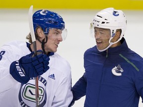 Adam Gaudette and Manny Malhotra chat during an on-ice session at 2019 Canucks training camp in Victoria.