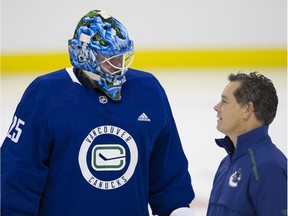 Jacob Markstrom talks with goalie coach Ian Clark during the second day of 2019 Canucks training camp in Victoria in September.