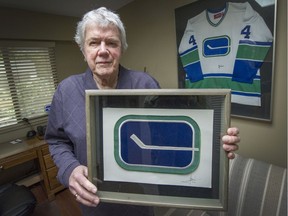 Joe Borovich holds an original Vancouver Canucks logo at his home in West Vancouver on Feb. 12, 2016. Borovich created this logo in 1970.