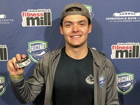Utica Comets goaltender Mike DiPietro poses with the puck after his first professional win on Wednesday night.