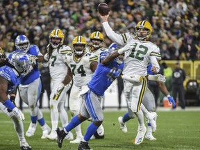 Oct 14, 2019; Green Bay, WI, USA; Green Bay Packers quarterback Aaron Rodgers (12) throws a pass while under pressure from Detroit Lions linebacker Devon Kennard (42) in the fourth quarter at Lambeau Field. Mandatory Credit: Benny Sieu-USA TODAY Sports