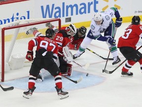 New Jersey Devils goaltender Mackenzie Blackwood (29) makes a save on Vancouver Canucks defenceman Tyler Myers  during the third period on Oct. 19.