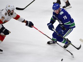 Florida Panthers defenceman Aaron Ekblad (5) reaches for the puck against Vancouver Canucks forward Micheal Ferland (79) during the third period.